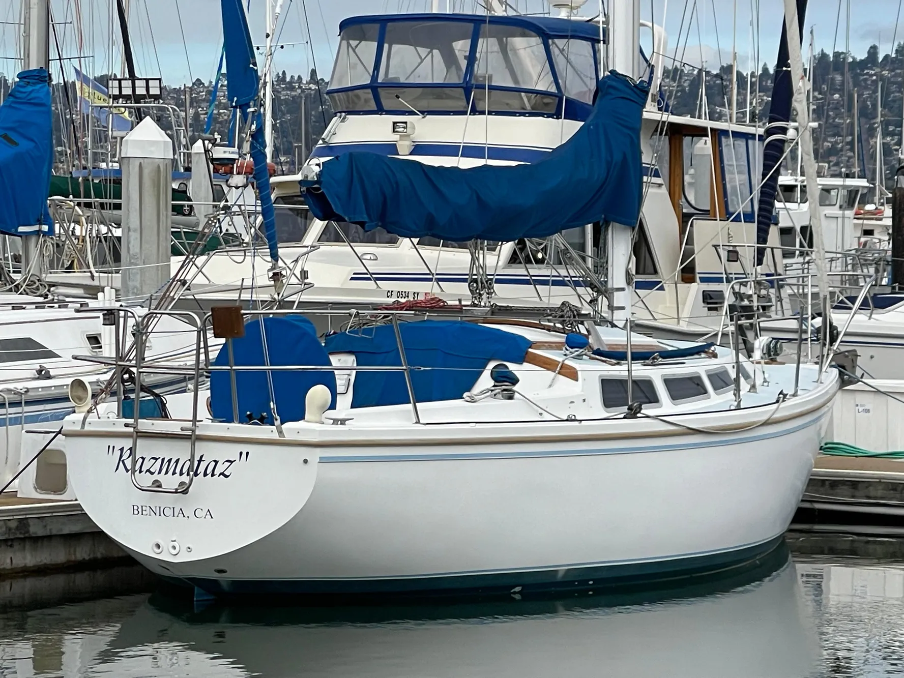1984 Catalina 30 sailboat "Kizmetaz" docked in Benicia, CA marina.
