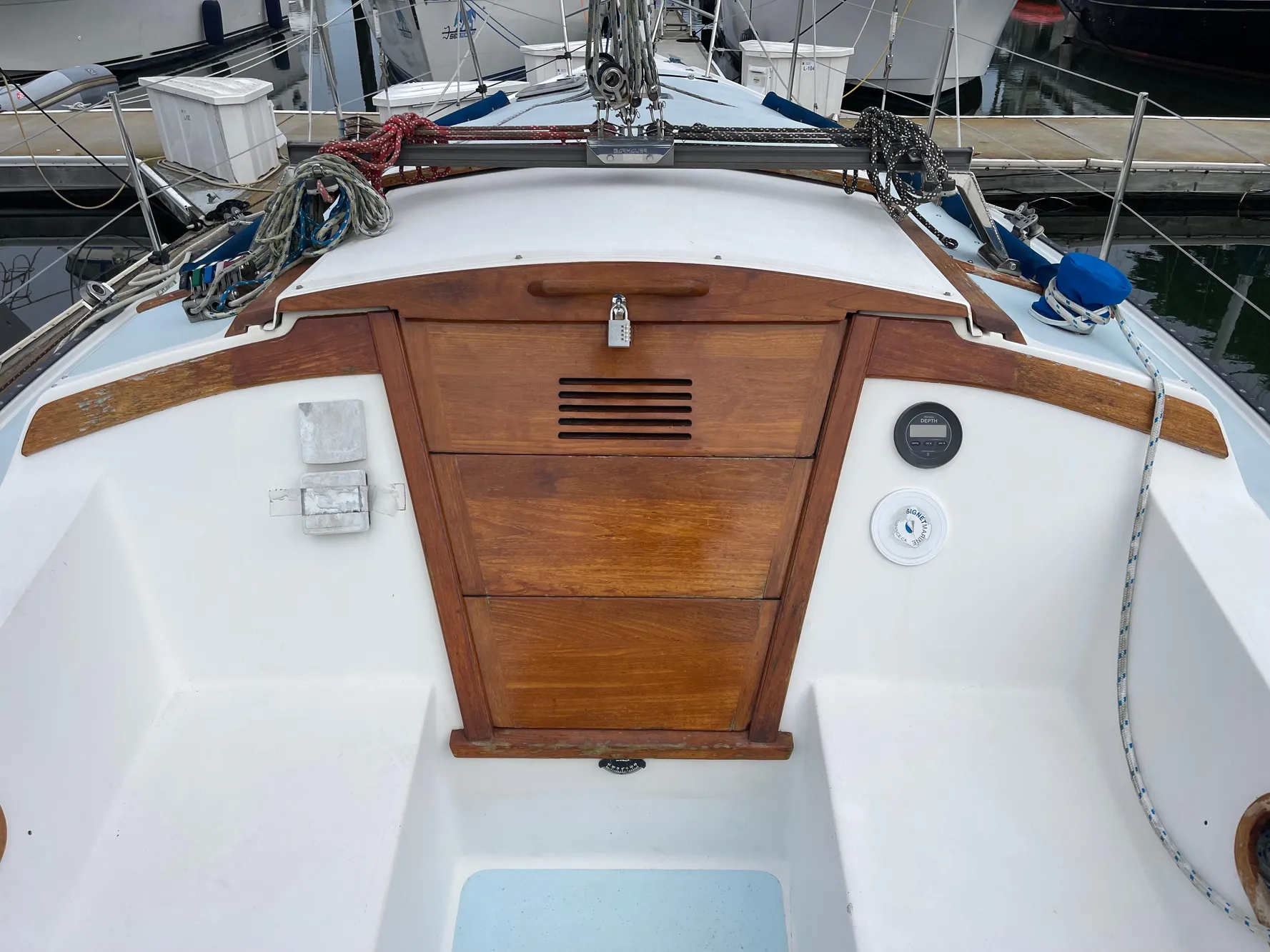 1984 Catalina 30 sailboat cockpit with wooden hatch and nautical equipment.