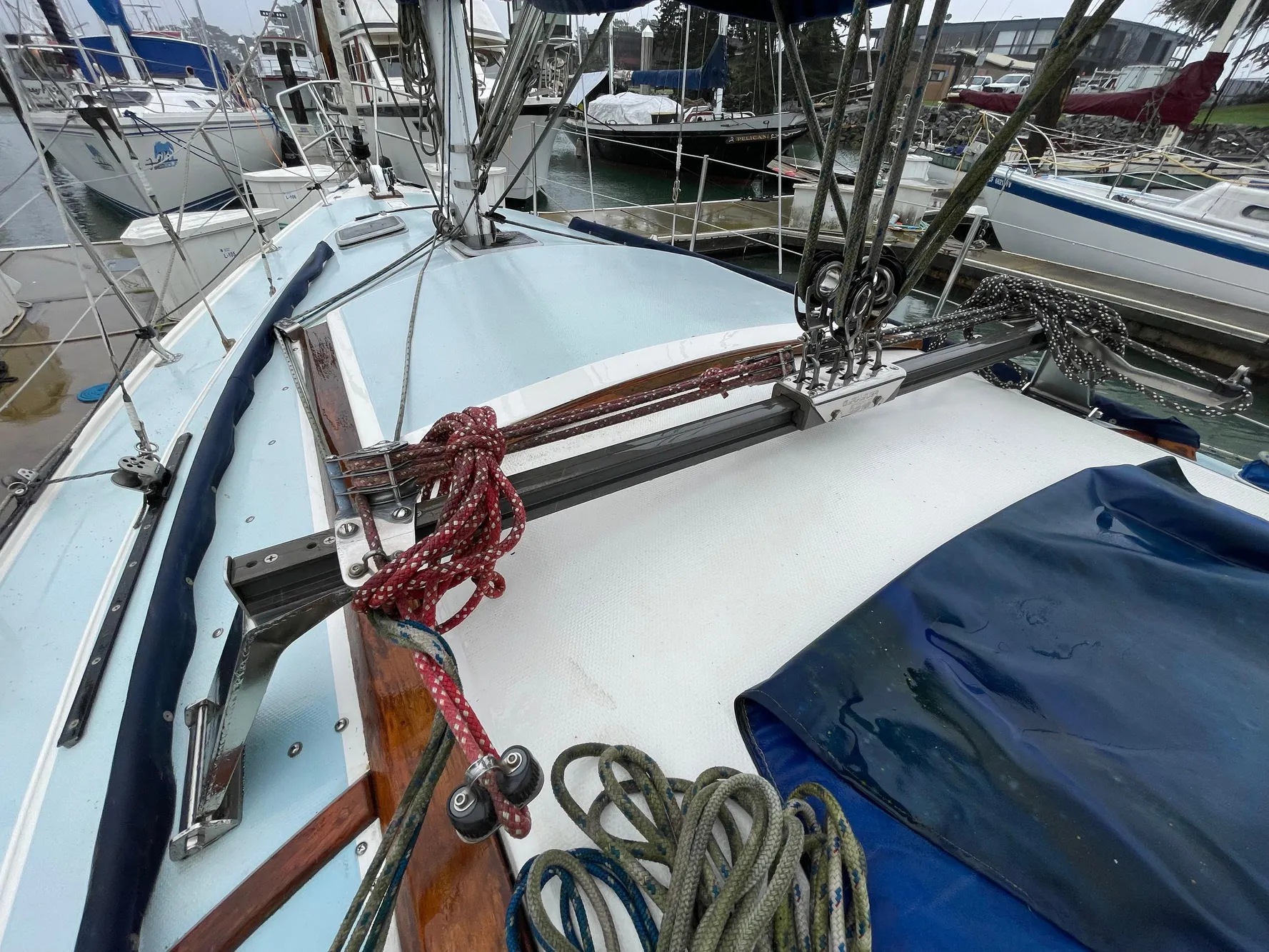 1984 Catalina 30 sailboat deck with ropes and rigging in a marina setting.