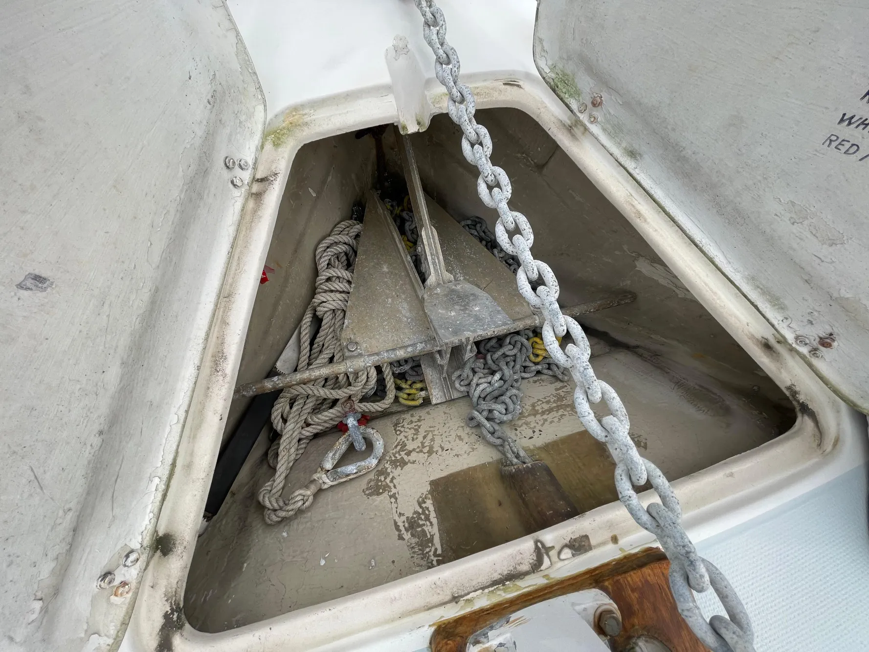 Anchor locker of 1984 Catalina 30 sailboat with chain and rope storage.