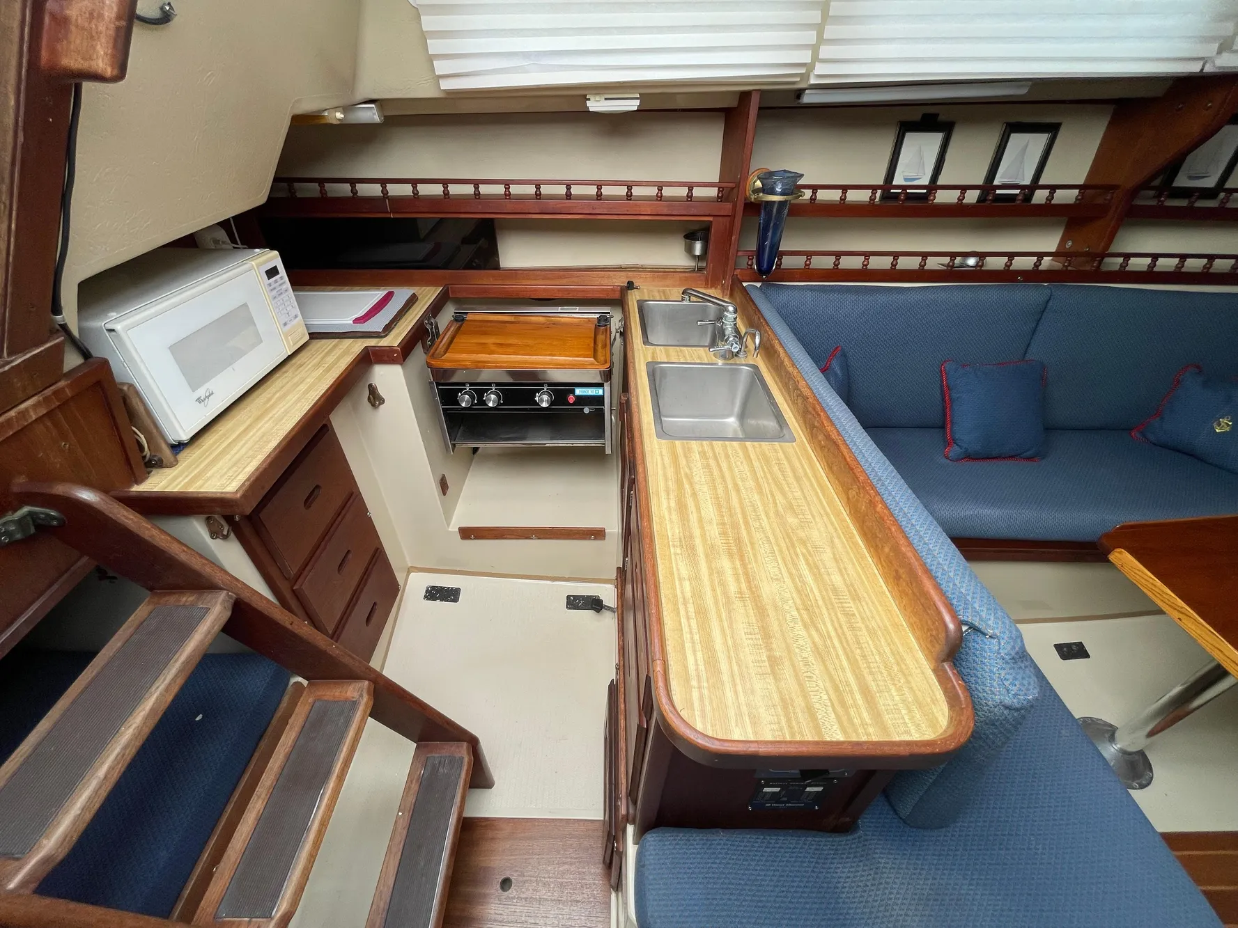 Interior of a 1984 Catalina 30 sailboat with kitchen and seating area.