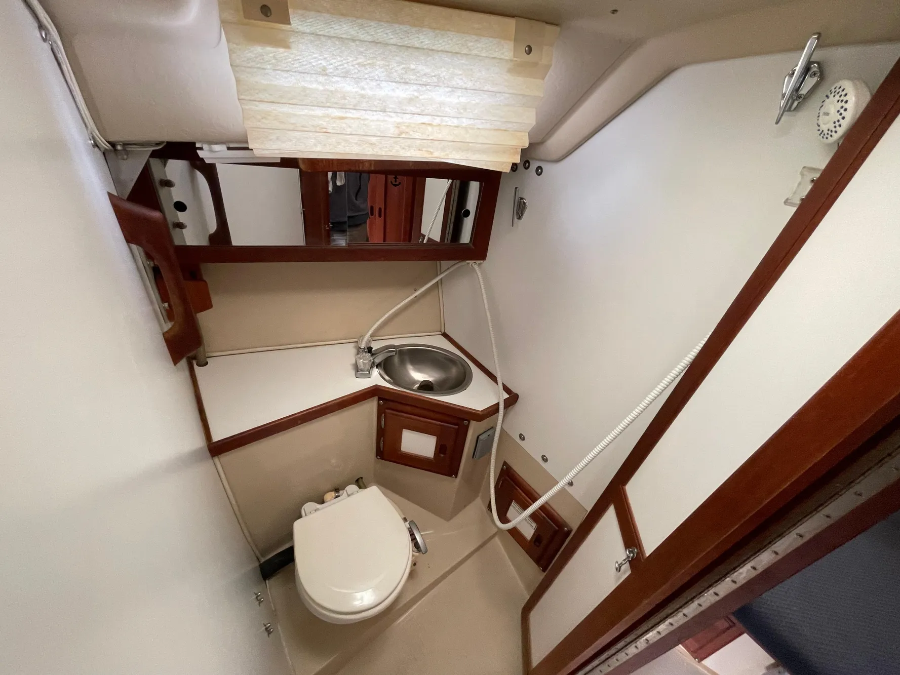 1984 Catalina 30 yacht bathroom with sink, toilet, and wooden accents.