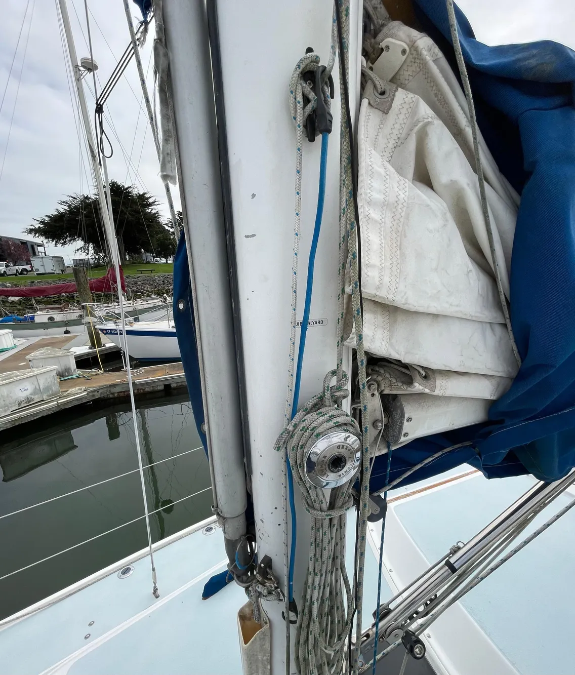 Close-up of a 1984 Catalina 30 sailboat mast and rigging at a marina.