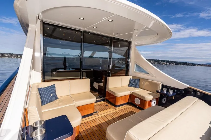  Yacht Photos Pics Luxurious 2022 Filippetti Classic 54 yacht deck with elegant seating and scenic water views.