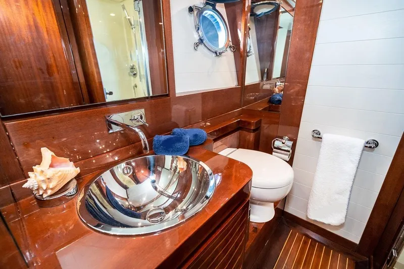  Yacht Photos Pics Luxurious bathroom in 2022 Filippetti Classic 54 yacht with elegant wood finish.