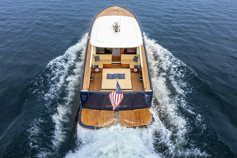  Yacht Photos Pics Filippetti Classic 54 yacht cruising on open water, rear view, 2022 model.