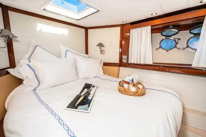  Yacht Photos Pics Luxurious cabin interior of 2022 Filippetti Classic 54 yacht with cozy bedding.