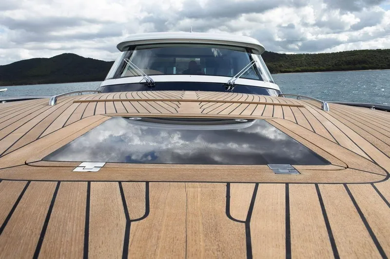  Yacht Photos Pics 2022 Filippetti Classic 54 yacht with sleek wooden deck and scenic ocean view.