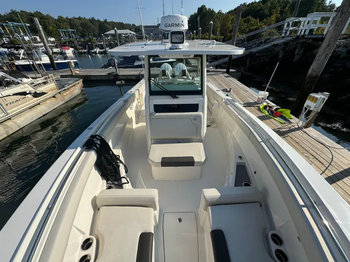  Yacht Photos Pics 2023 Sailfish 312 CC boat docked at marina, featuring spacious deck and Garmin equipment.