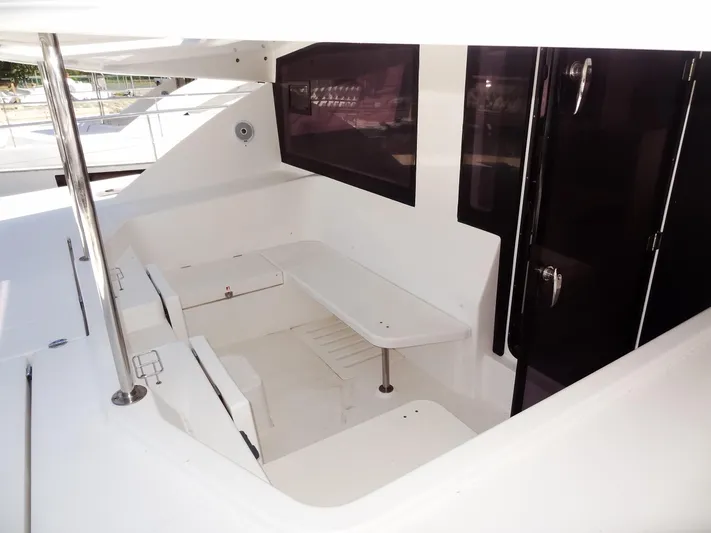 Makin Wind Yacht Photos Pics 2017 Leopard 51 Powercat cockpit seating area with table and storage.