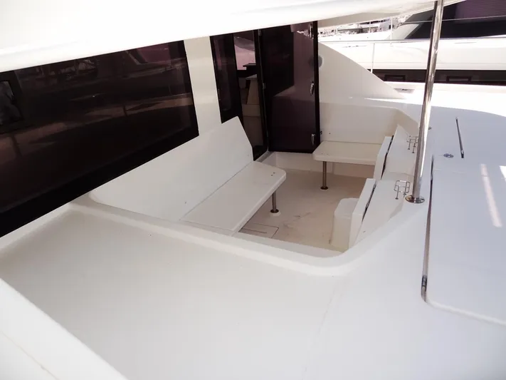 Makin Wind Yacht Photos Pics 2017 Leopard 51 Powercat yacht seating area with white benches and tables.