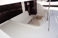 2017 Leopard 51 Powercat yacht seating area with white benches and tables.
