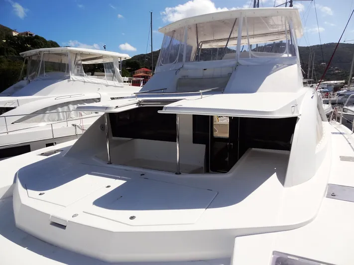 Makin Wind Yacht Photos Pics 2017 Leopard 51 Powercat yacht docked in a marina under a clear blue sky.