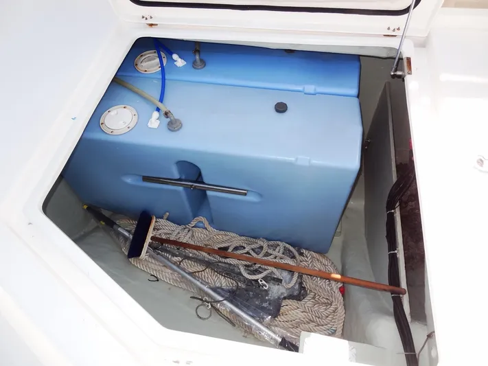Makin Wind Yacht Photos Pics Storage compartment of a 2017 Leopard 51 Powercat with blue water tanks and boating equipment.