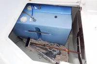 Storage compartment of a 2017 Leopard 51 Powercat with blue water tanks and boating equipment.