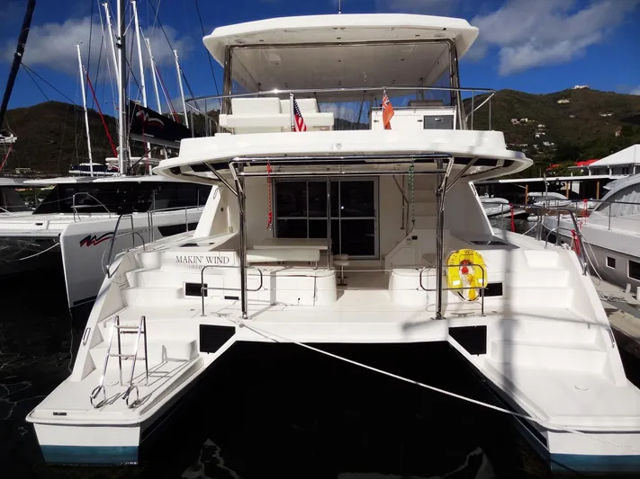 Makin Wind Yacht Photos Pics 2017 Leopard 51 Powercat yacht docked at marina with mountainous backdrop.