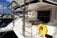 2017 Leopard 51 Powercat yacht docked at marina, featuring spacious deck and seating area.