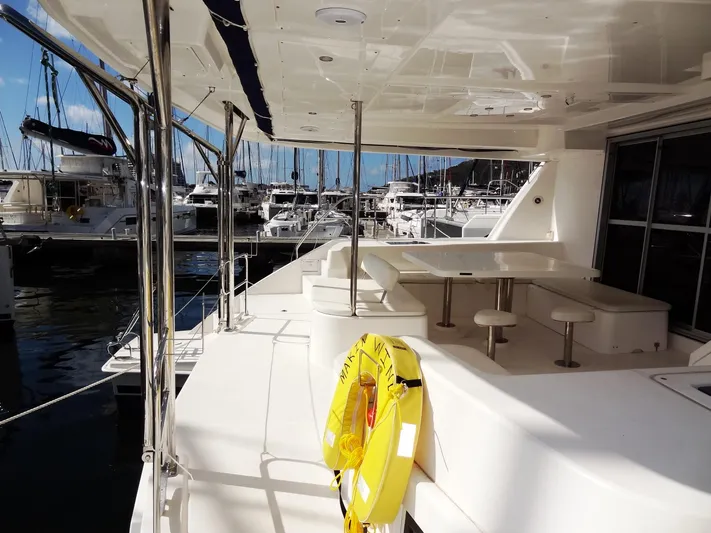 Makin Wind Yacht Photos Pics 2017 Leopard 51 Powercat yacht deck with seating area and marina view.