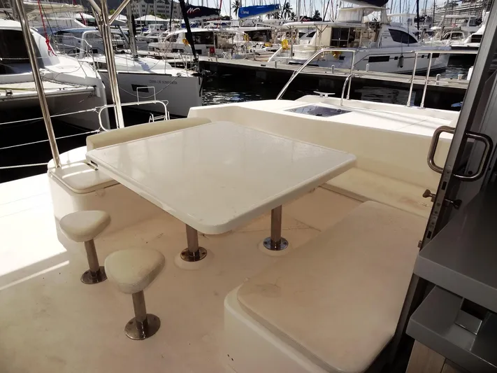 Makin Wind Yacht Photos Pics 2017 Leopard 51 Powercat yacht with outdoor seating and table in marina.