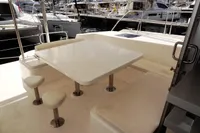 2017 Leopard 51 Powercat yacht with outdoor seating and table in marina.