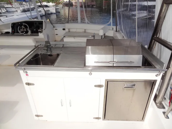 Makin Wind Yacht Photos Pics Outdoor kitchen on a 2017 Leopard 51 Powercat yacht with sink, grill, and storage.