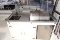 Outdoor kitchen on a 2017 Leopard 51 Powercat yacht with sink, grill, and storage.