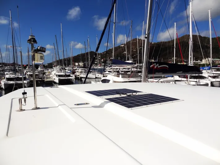 Makin Wind Yacht Photos Pics 2017 Leopard 51 Powercat in a marina with solar panels on the roof.