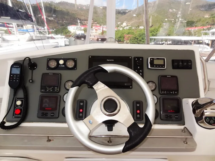 Makin Wind Yacht Photos Pics 2017 Leopard 51 Powercat helm with steering wheel and navigation controls.