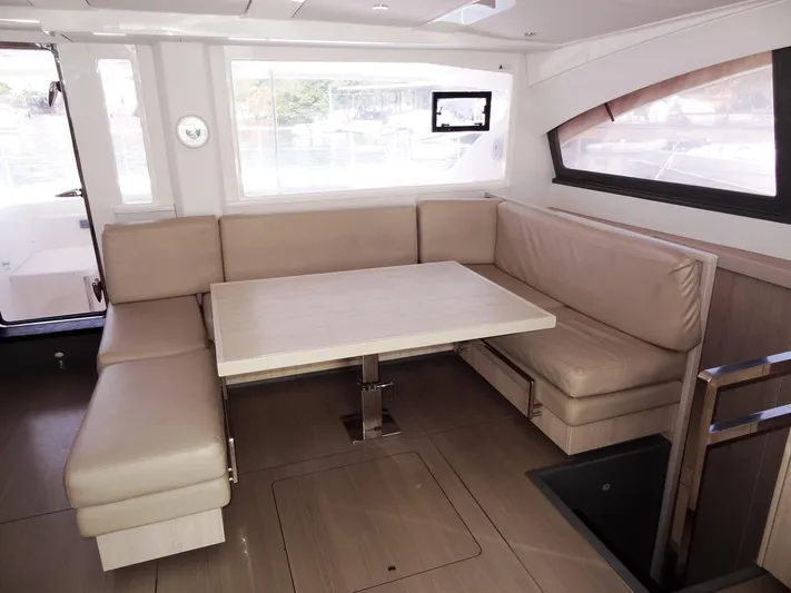 Makin Wind Yacht Photos Pics 2017 Leopard 51 Powercat interior with beige seating and dining table.