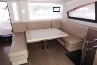 2017 Leopard 51 Powercat interior with beige seating and dining table.