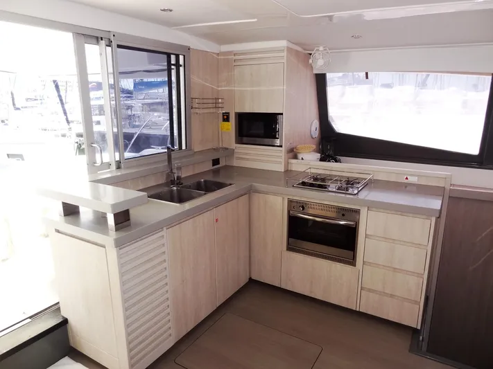 Makin Wind Yacht Photos Pics Modern kitchen interior of 2017 Leopard 51 Powercat yacht with light wood cabinetry.