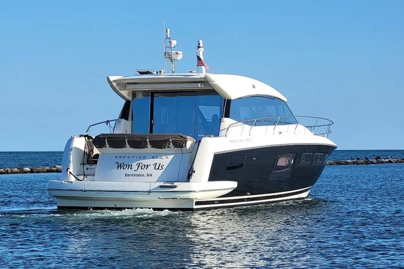  Yacht Photos Pics 2013 Prestige 500 S yacht cruising on open water, rear view.