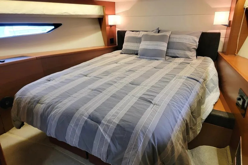  Yacht Photos Pics Luxurious bedroom interior of 2013 Prestige 500 S yacht with striped bedding.
