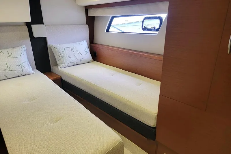  Yacht Photos Pics Interior cabin of 2013 Prestige 500 S yacht with twin beds and window view.