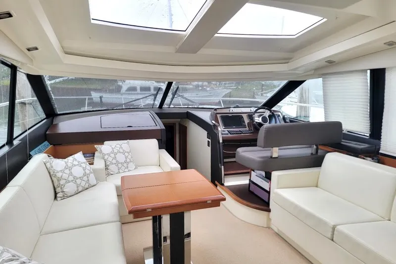  Yacht Photos Pics Luxurious interior of a 2013 Prestige 500 S yacht with plush seating and modern helm.