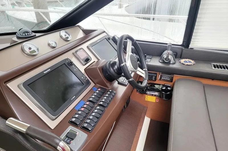  Yacht Photos Pics Interior helm of 2013 Prestige 500 S yacht with modern navigation controls.