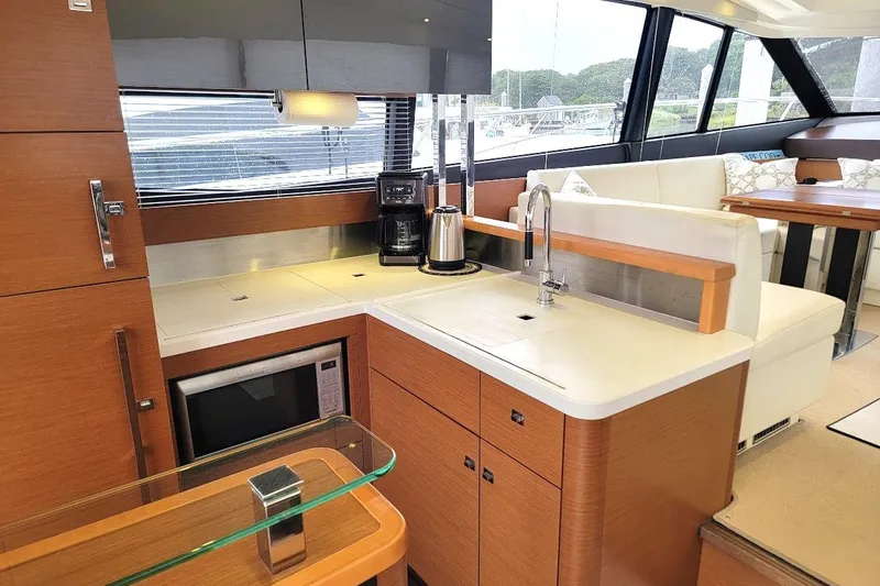  Yacht Photos Pics Luxurious 2013 Prestige 500 S yacht interior with modern kitchen and seating area.