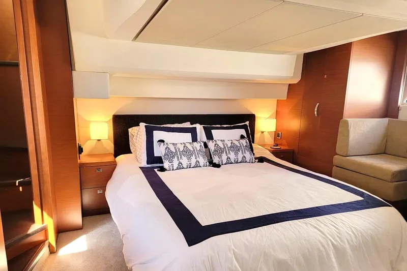  Yacht Photos Pics Luxurious bedroom interior of 2013 Prestige 500 S yacht with elegant bedding and warm lighting.