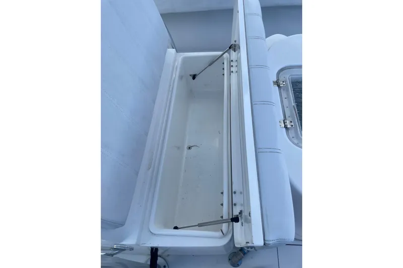  Yacht Photos Pics Open storage compartment on 2016 Contender 39 ST boat, featuring white cushioned seating.