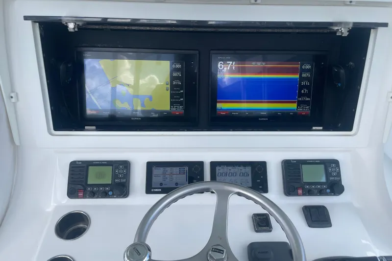  Yacht Photos Pics 2016 Contender 39 ST boat dashboard with Garmin navigation displays and controls.