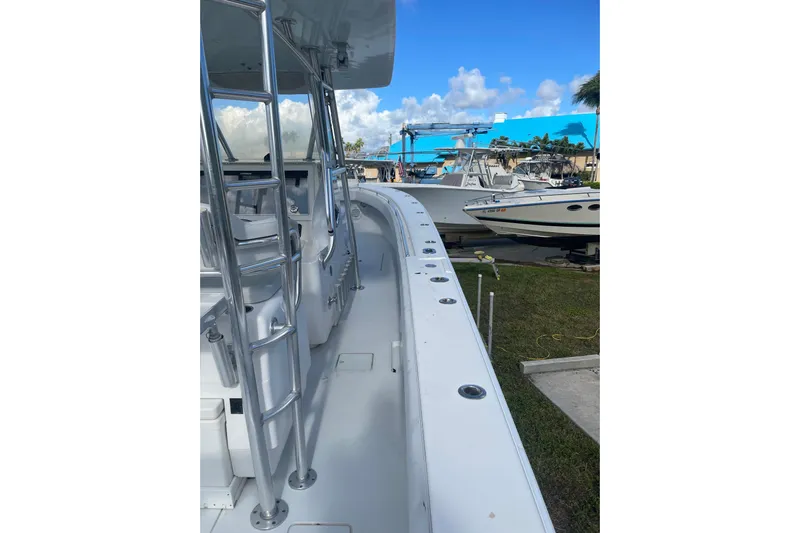  Yacht Photos Pics 2016 Contender 39 ST boat docked, showcasing sleek design and spacious deck.