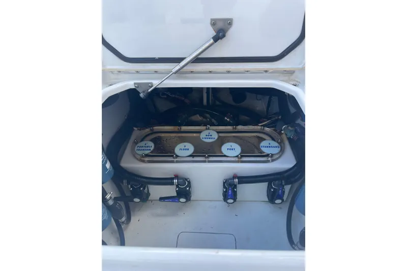  Yacht Photos Pics 2016 Contender 39 ST boat compartment with labeled valves and hoses.