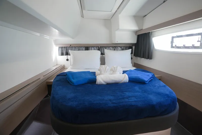 Firefly Yacht Photos Pics Luxurious cabin interior of 2023 Fountaine Pajot Isla 40 catamaran with cozy bedding.