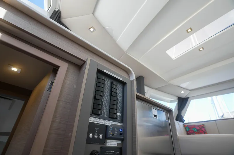 Firefly Yacht Photos Pics Interior of 2023 Fountaine Pajot Isla 40 catamaran, featuring control panel and modern design.