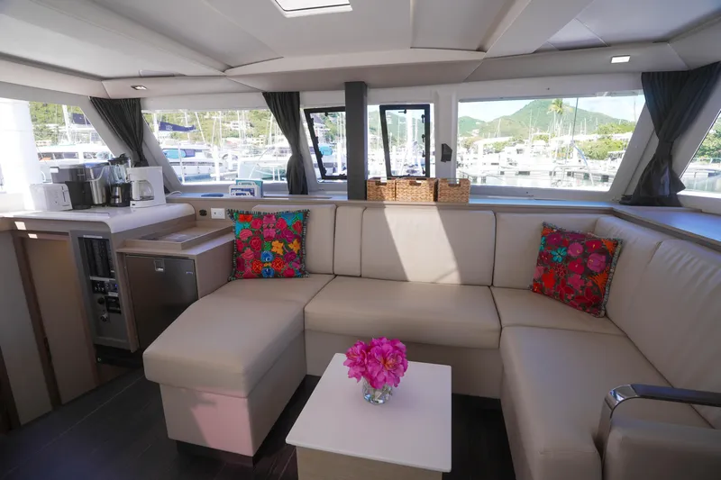 Firefly Yacht Photos Pics Luxurious interior of 2023 Fountaine Pajot Isla 40 catamaran with modern seating and vibrant decor.