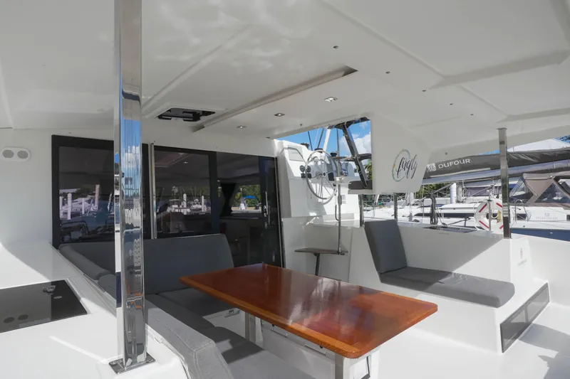 Firefly Yacht Photos Pics 2023 Fountaine Pajot Isla 40 yacht interior with seating and dining area.