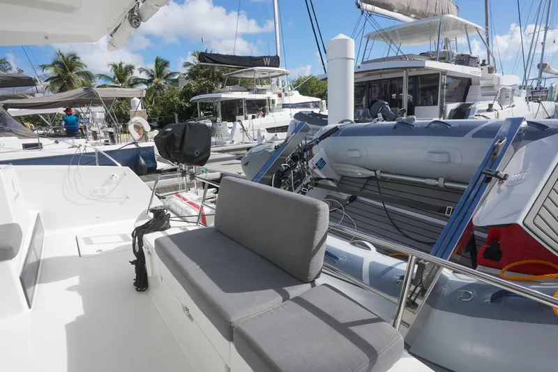 Firefly Yacht Photos Pics 2023 Fountaine Pajot Isla 40 catamaran docked, featuring a spacious deck and seating area.