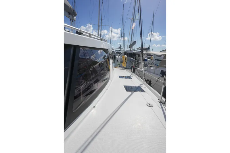 Firefly Yacht Photos Pics 2023 Fountaine Pajot Isla 40 catamaran deck view with marina background.