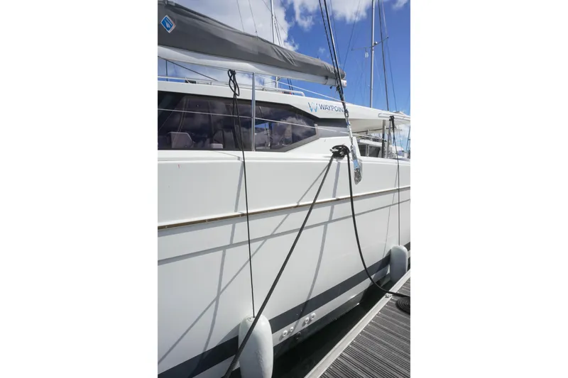 Firefly Yacht Photos Pics 2023 Fountaine Pajot Isla 40 catamaran docked, showcasing sleek design and modern features.