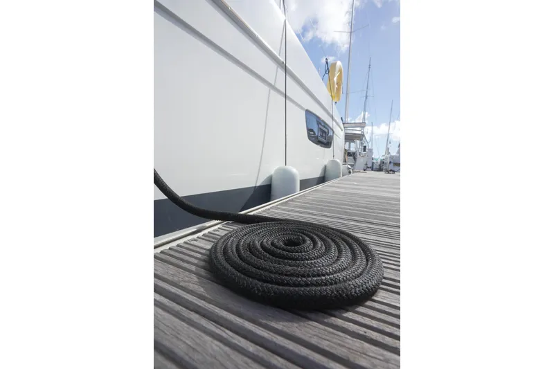 Firefly Yacht Photos Pics 2023 Fountaine Pajot Isla 40 yacht docked with coiled rope on pier.